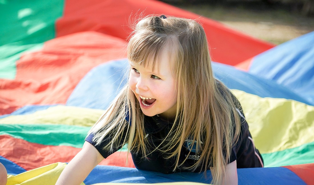 girl on-jumbo-parachuteat early learning center